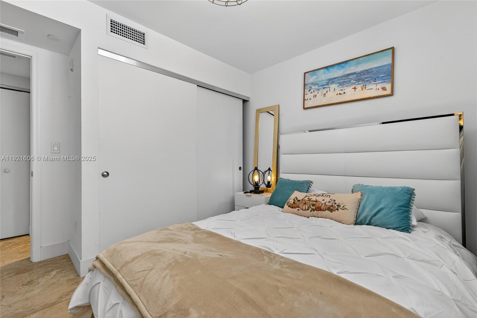 9821 East Bay Harbor Drive, Unit 402 Bay Harbor Islands, FL 33154 - Photo 24 of 34 a bedroom with a bed and wooden floor