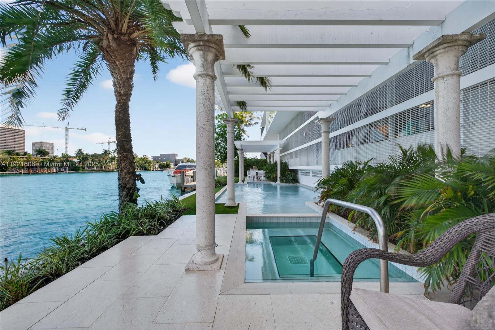 9821 East Bay Harbor Drive, Unit 402 Bay Harbor Islands, FL 33154 - Photo 26 of 34 a view of a porch with furniture and a garden