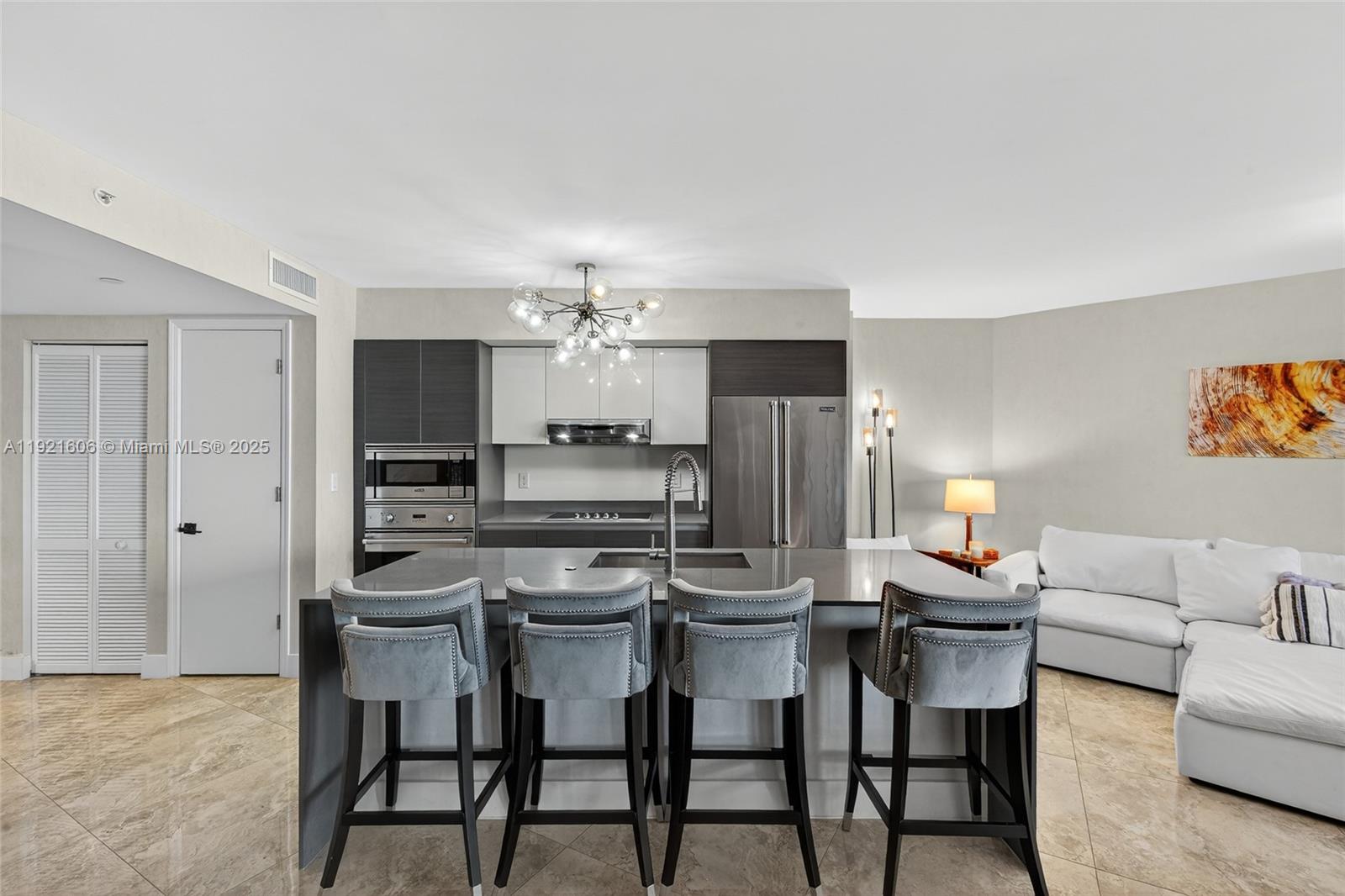 9821 East Bay Harbor Drive, Unit 402 Bay Harbor Islands, FL 33154 - Photo 5 of 34 a view of a dining room with furniture and chandelier