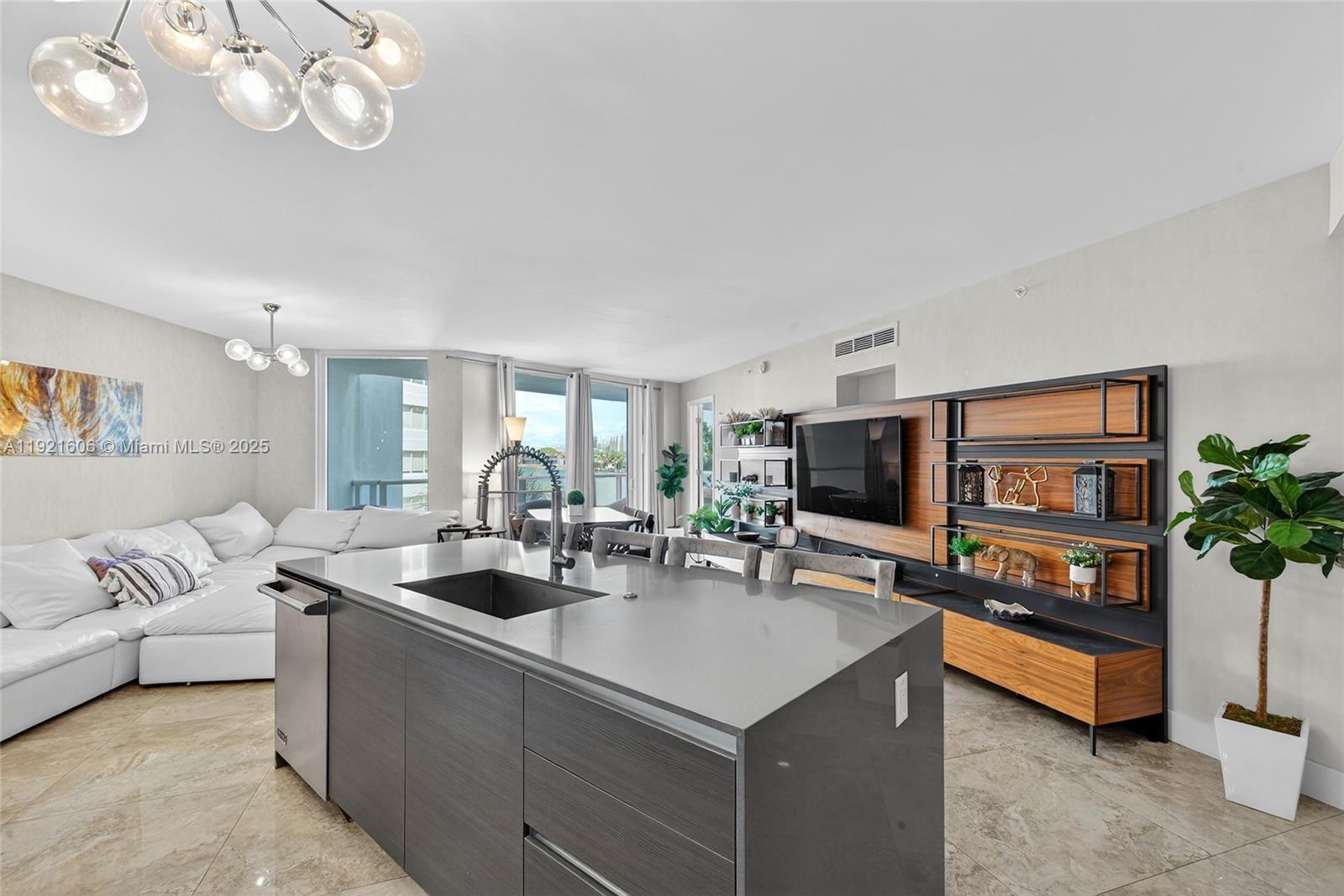 9821 East Bay Harbor Drive, Unit 402 Bay Harbor Islands, FL 33154 - Photo 7 of 34 a living room with furniture and a flat screen tv