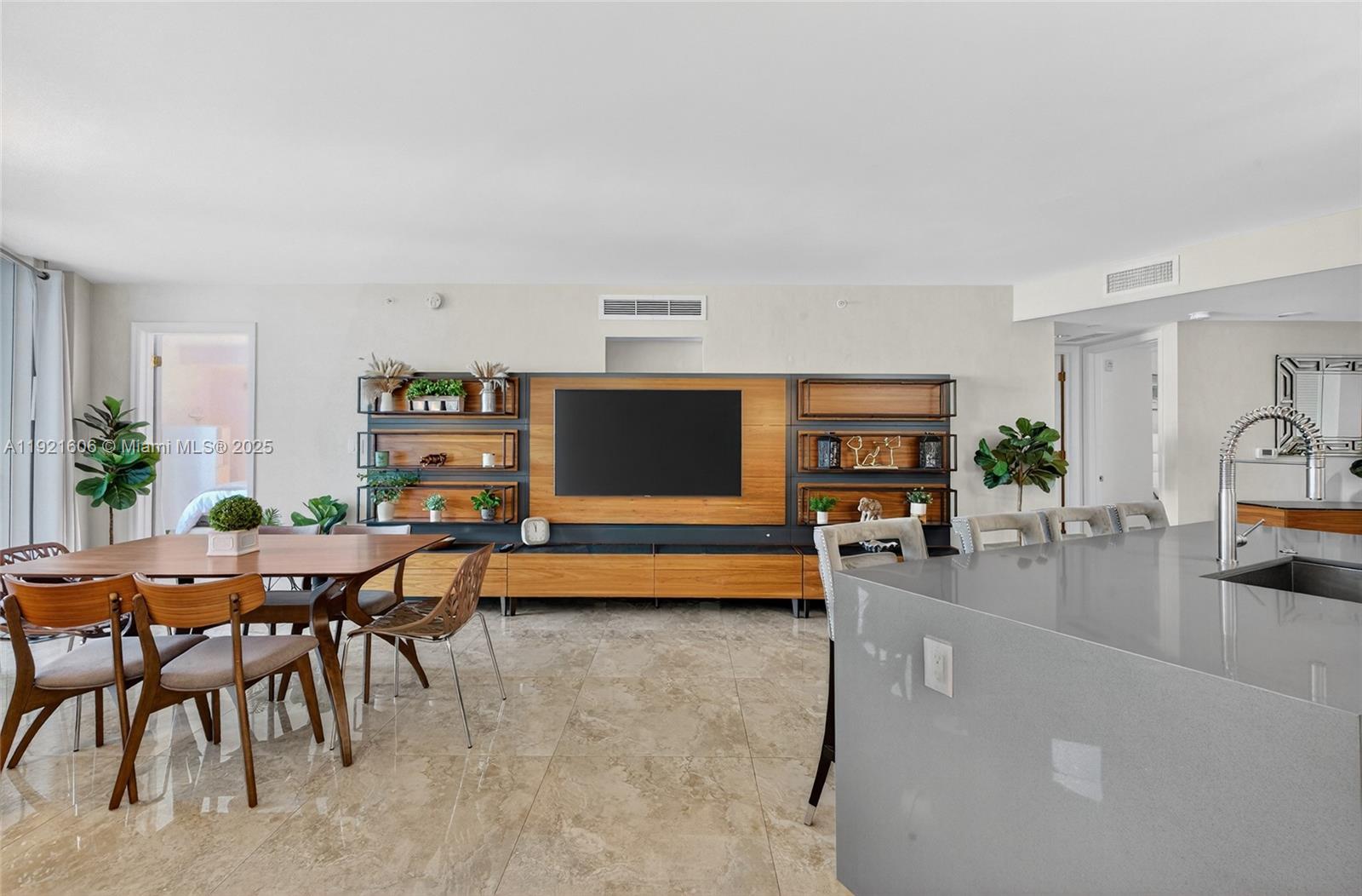 9821 East Bay Harbor Drive, Unit 402 Bay Harbor Islands, FL 33154 - Photo 8 of 34 a living room with furniture and a flat screen tv