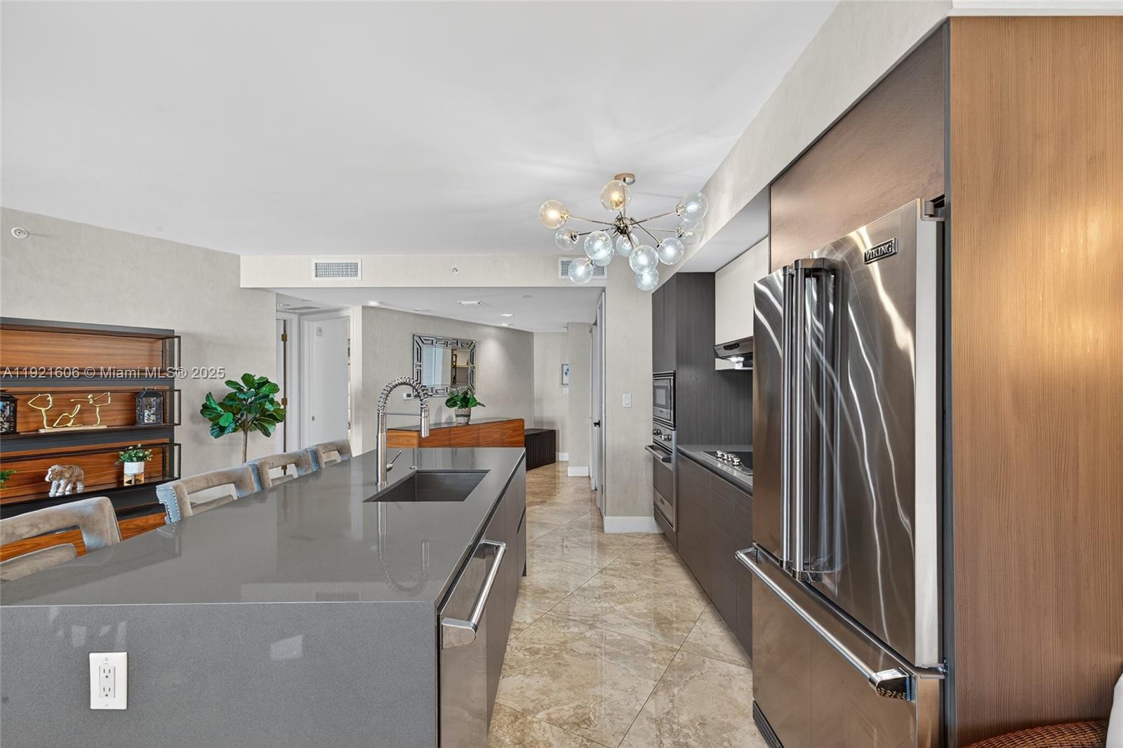 9821 East Bay Harbor Drive, Unit 402 Bay Harbor Islands, FL 33154 - Photo 9 of 34 a view of a living room and a chandelier