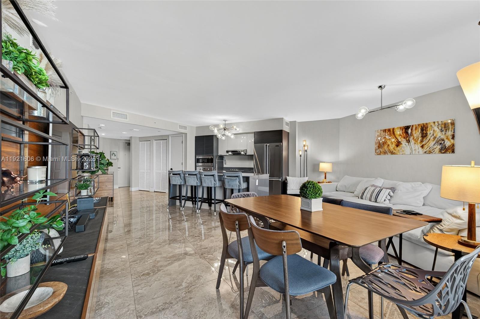 9821 East Bay Harbor Drive, Unit 402 Bay Harbor Islands, FL 33154 - Photo 10 of 34 a view of a dining room with furniture and a potted plant