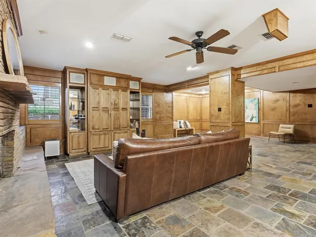 a large kitchen with stainless steel appliances a stove a sink dishwasher and a dining table with wooden floor