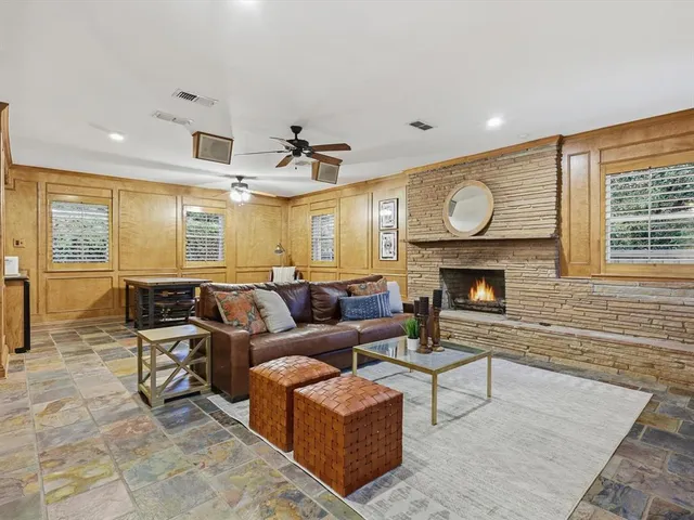 a living room with furniture a fireplace and wooden floor