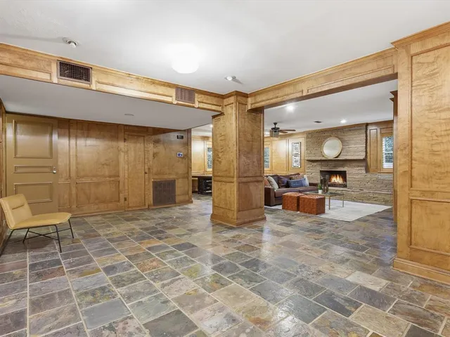 a view of a lobby with a rug and a glass door