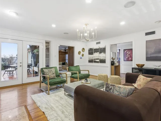 a living room with furniture and a chandelier
