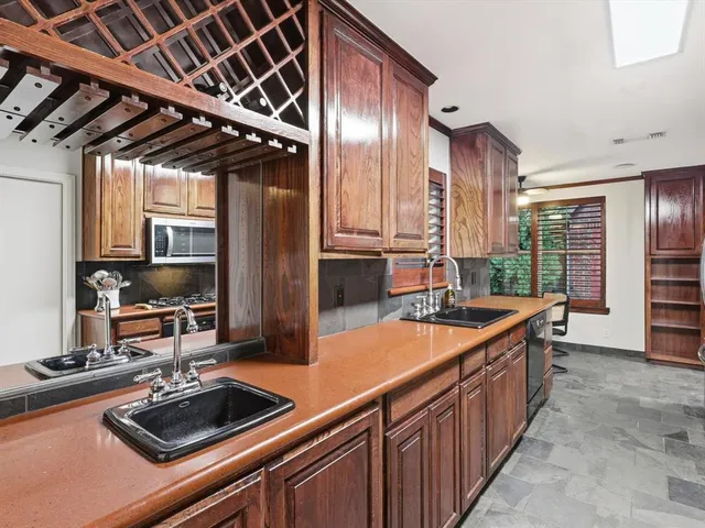 a kitchen with stainless steel appliances a sink stove and cabinets