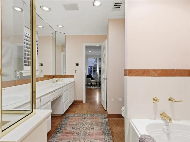 a large bathroom with a tub shower and sink