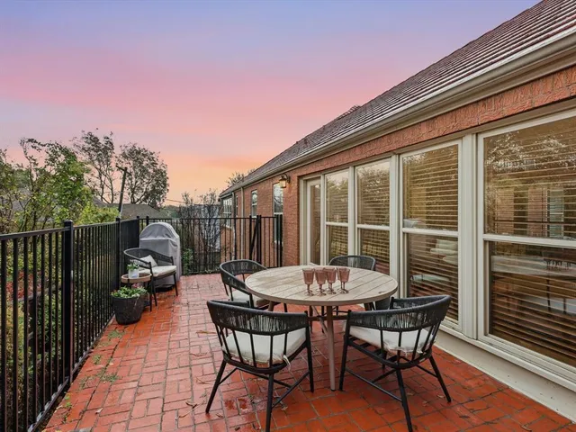 a view of a dinning table and chairs in the balcony