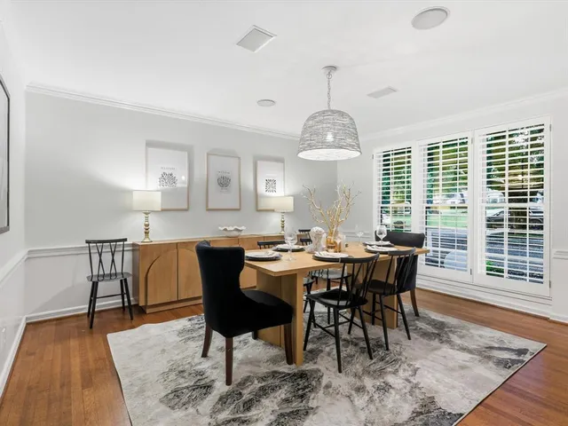 a view of a dining room with furniture window and wooden floor