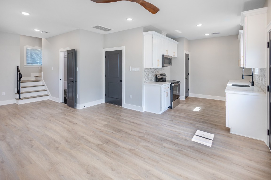 5036 Mallow Street, Unit B Houston, TX 77033 - Photo 12 of 36 a kitchen with stainless steel appliances granite countertop a refrigerator and a stove top oven