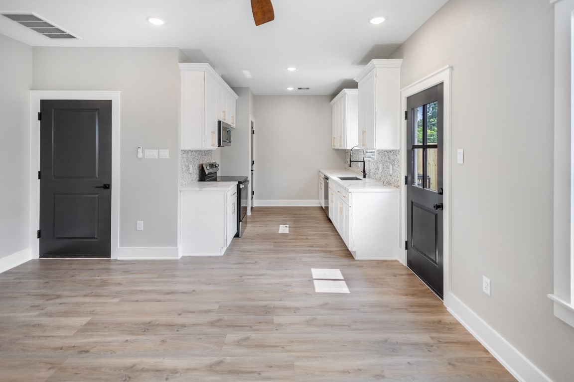 5036 Mallow Street, Unit B Houston, TX 77033 - Photo 13 of 36 a view of a kitchen with refrigerator and wooden floor