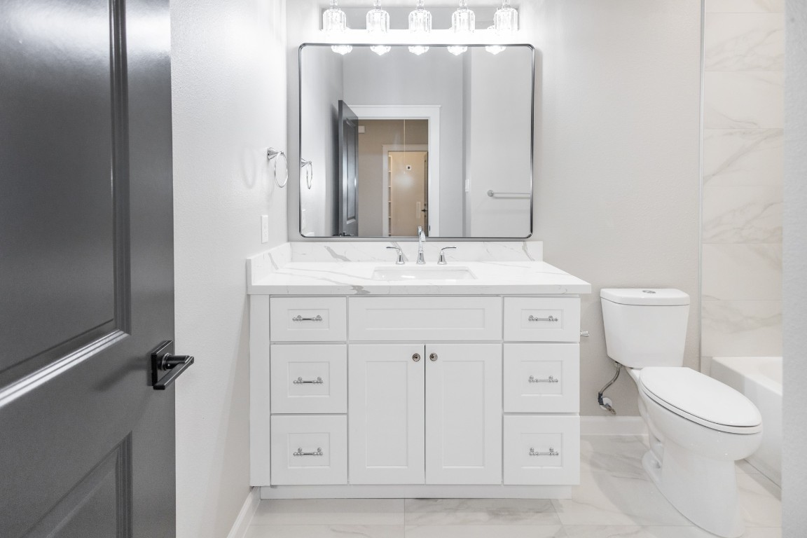 5036 Mallow Street, Unit B Houston, TX 77033 - Photo 30 of 36 a bathroom with a toilet sink and mirror