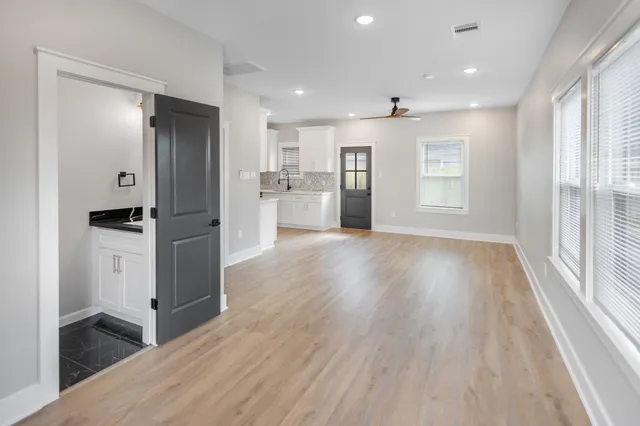 a view of kitchen with sink and refrigerator