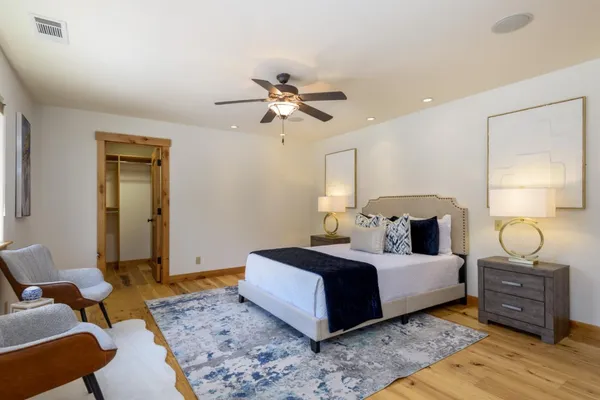 a bedroom with a bed and wooden floor