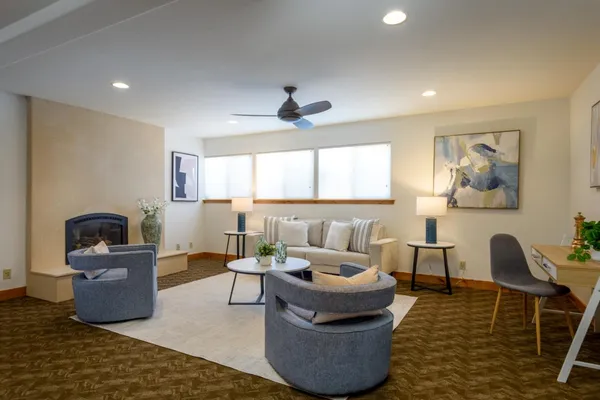 a living room with furniture fireplace and a window