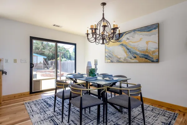 a dining room with furniture a rug and a chandelier