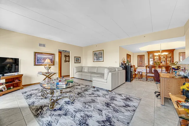 a living room with furniture a flat screen tv and a table