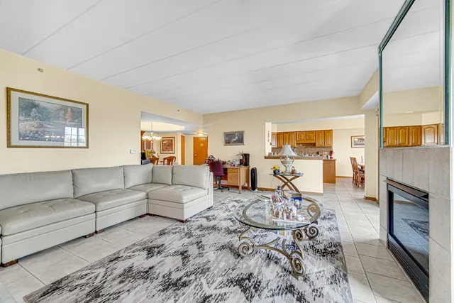 a living room with furniture a dining table and a fireplace
