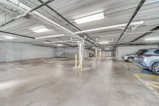 a view of parking garage with cars