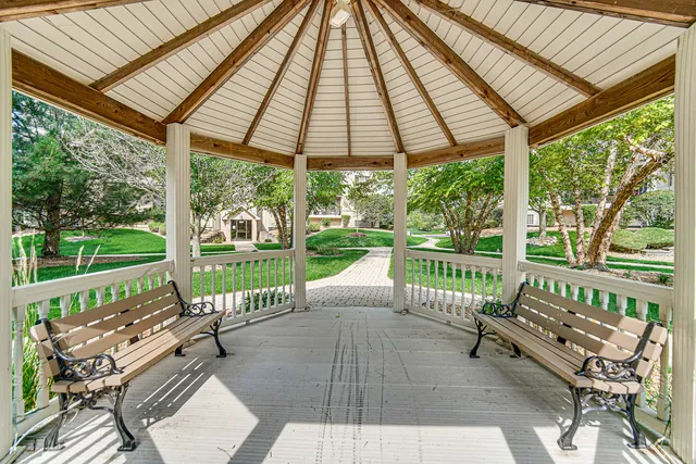 a view of a patio with a table chairs and a backyard