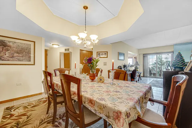 a view of a dining room with furniture and chandelier