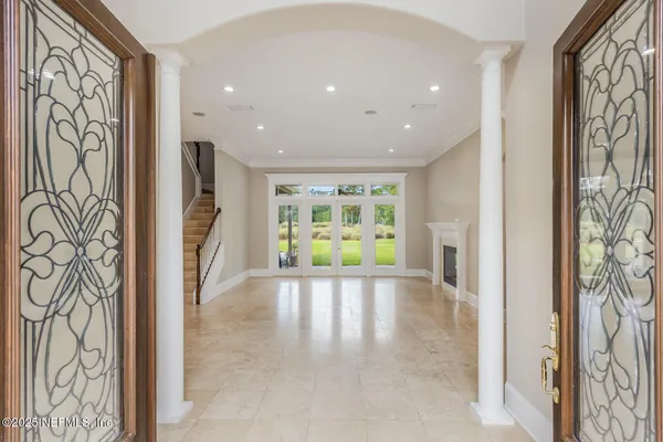 a bedroom with bed and a flat tv screen on dresser