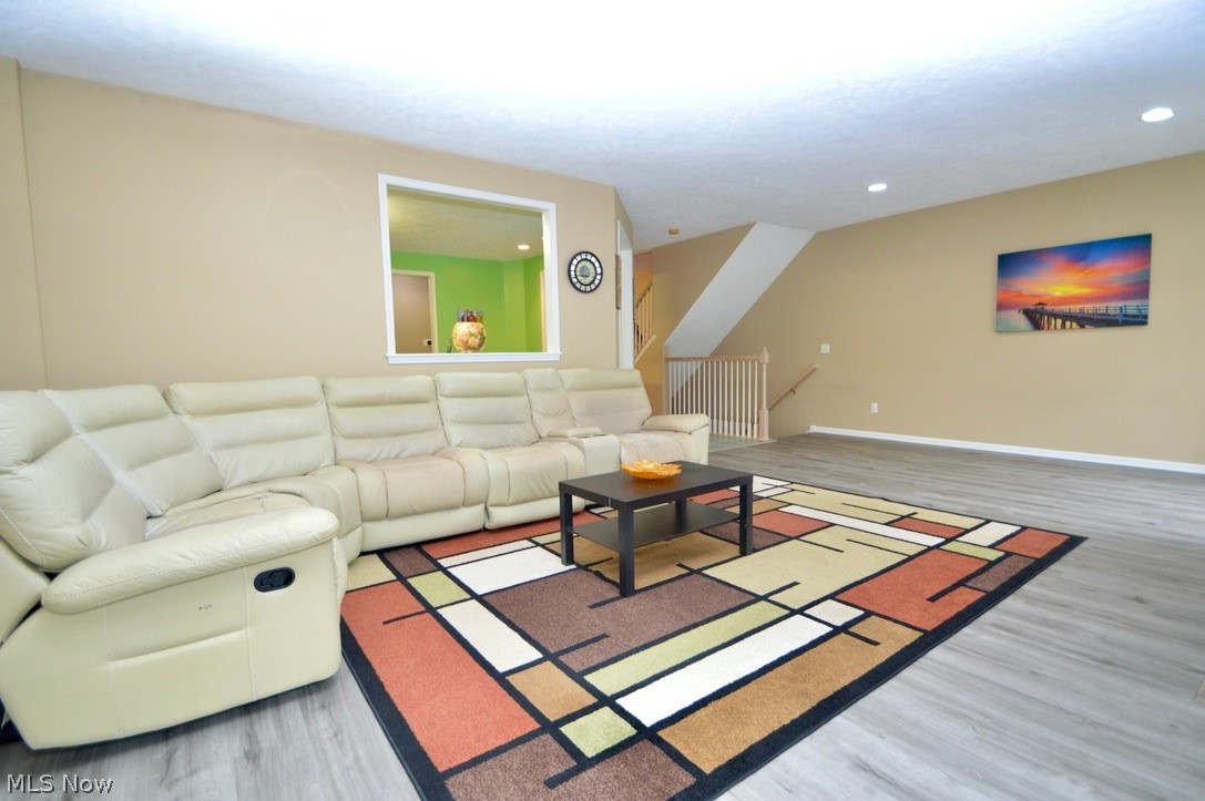 30247 Center Ridge Road, Unit 12 Westlake, OH 44145 - Photo 9 of 35 Spacious living room with opening to kitchen and staircase to lower level in the background