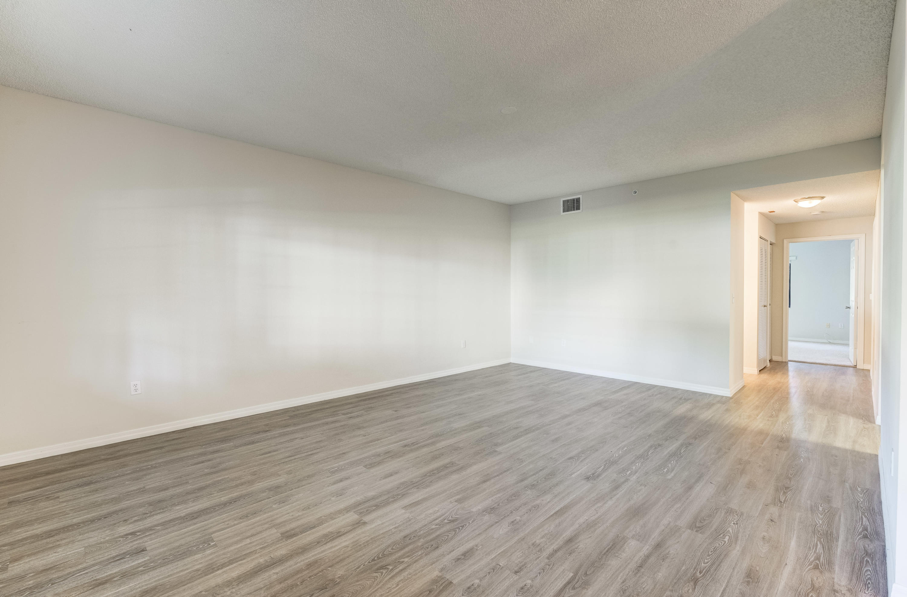 4685 Haverhill Road, Unit A11 West Palm Beach, FL 33417 - Photo 18 of 36 a view of an empty room and wooden floor