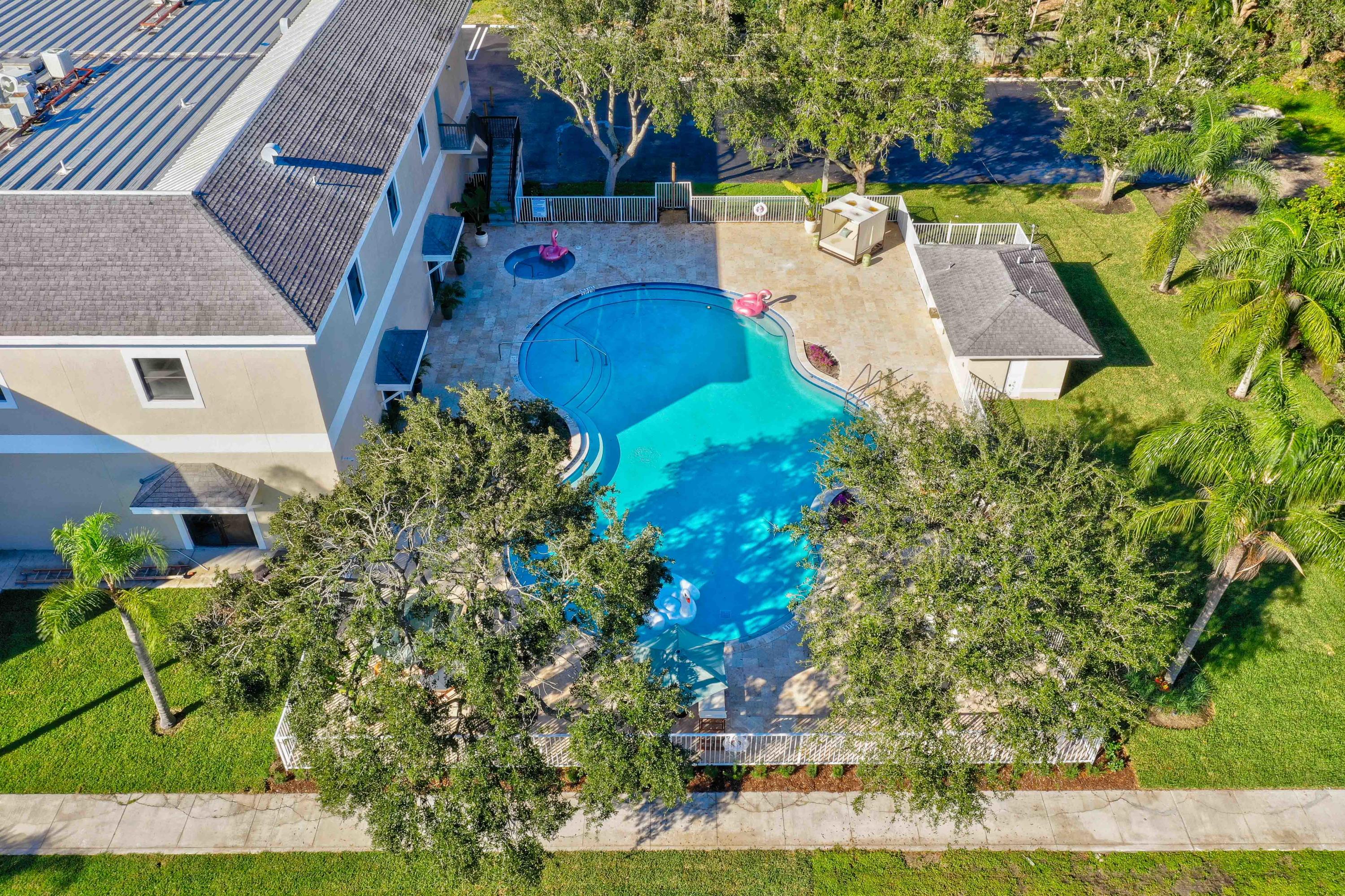 4685 Haverhill Road, Unit A11 West Palm Beach, FL 33417 - Photo 30 of 36 an aerial view of a house with a yard and trees
