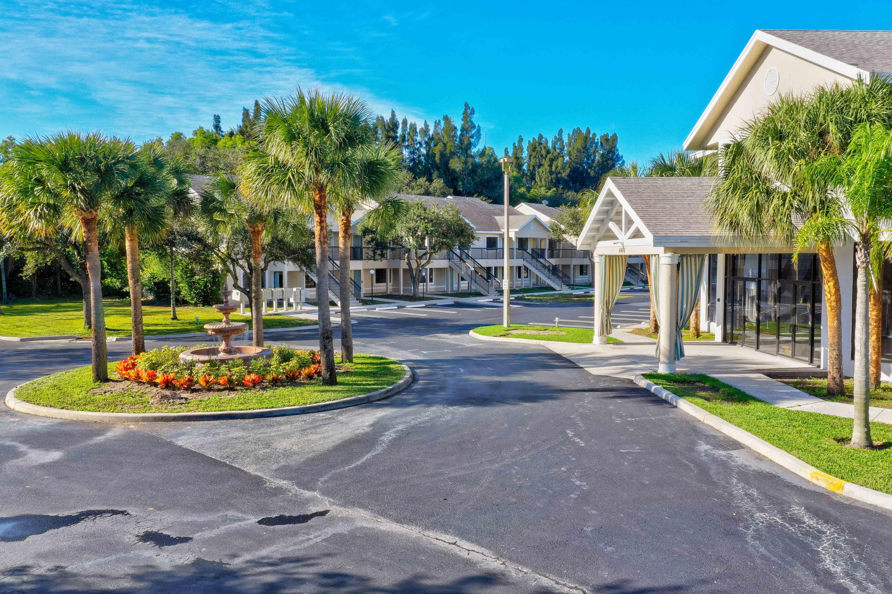 4685 Haverhill Road, Unit A11 West Palm Beach, FL 33417 - Photo 32 of 36 a view of a house with backyard and swimming pool