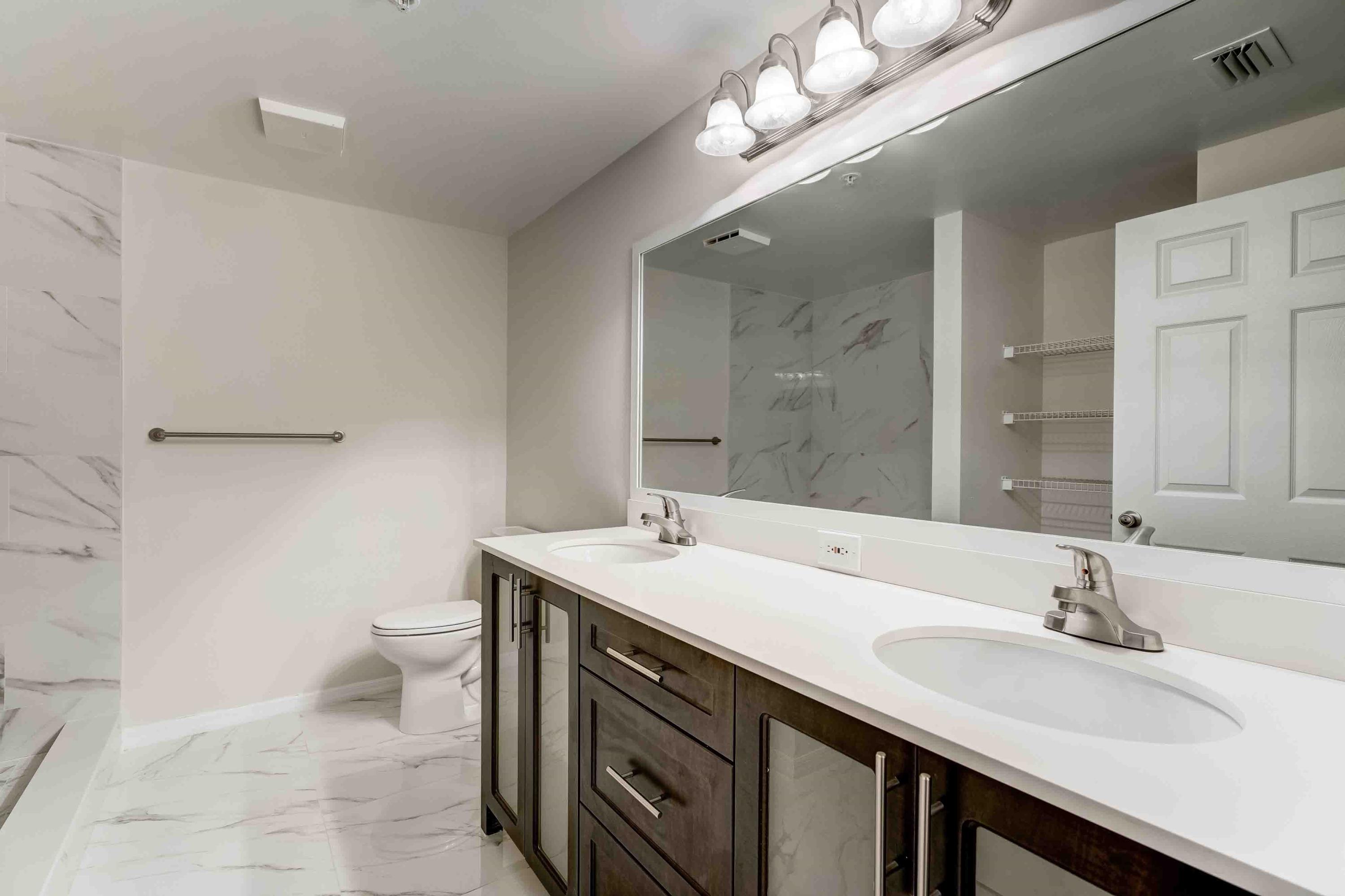 4685 Haverhill Road, Unit A11 West Palm Beach, FL 33417 - Photo 5 of 36 a bathroom with a sink a toilet and a mirror