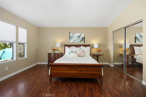 a bedroom with a bed and wooden floor