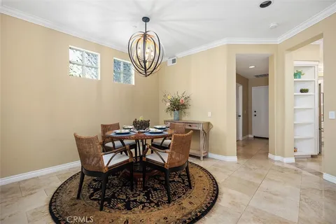 a view of a dining room that has a table and chairs