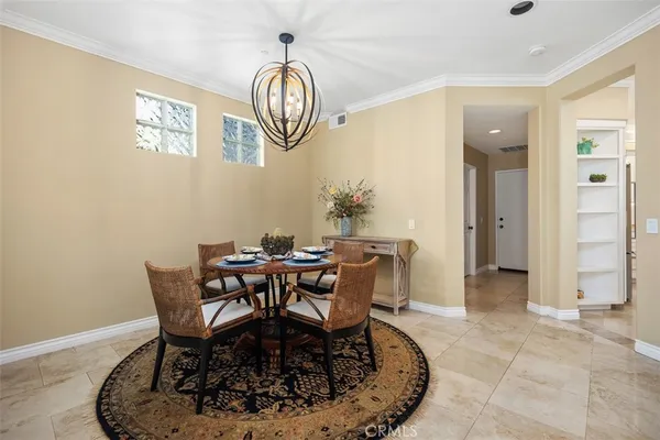 a view of a dining room that has a table and chairs