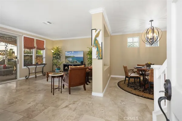 a dining room with furniture and a window