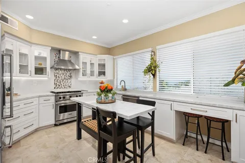 a kitchen with a table chairs stove and cabinets