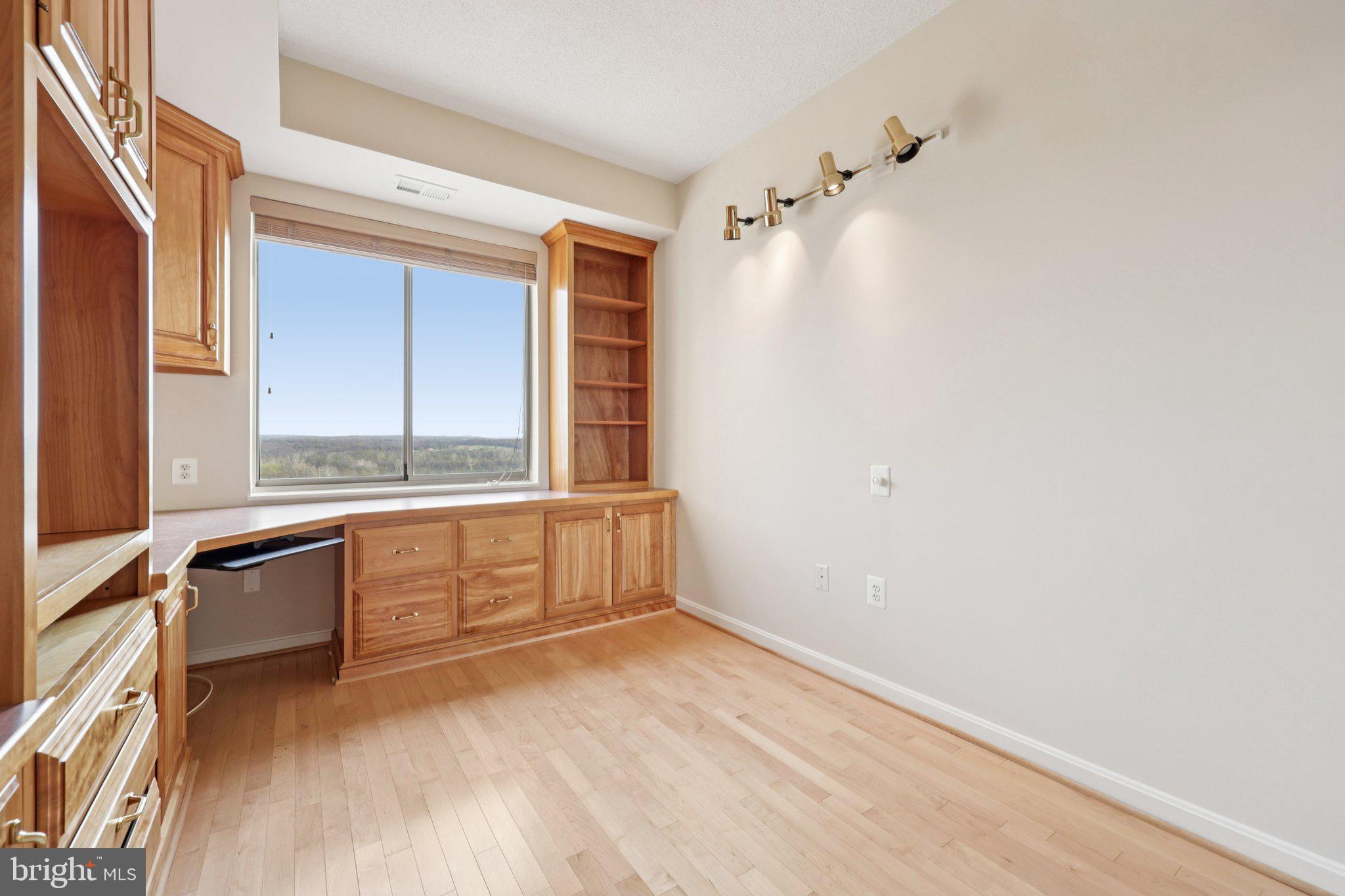19375 Cypress Ridge Terrace, Unit 1111 Leesburg, VA 20176 - Photo 22 of 52 Home office with builtin cabinets and shelving