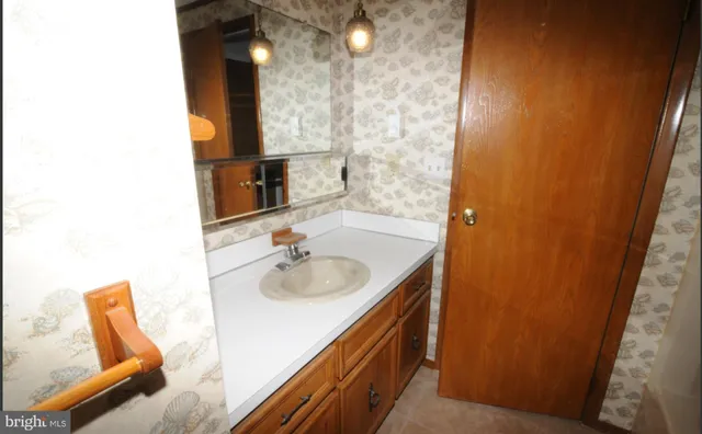 a bathroom with a sink and a mirror