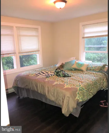 a bed sitting in a bedroom next to a window
