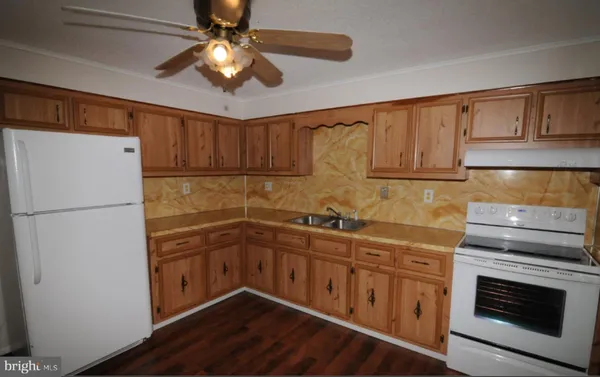 a kitchen with sink cabinets and stainless steel appliances