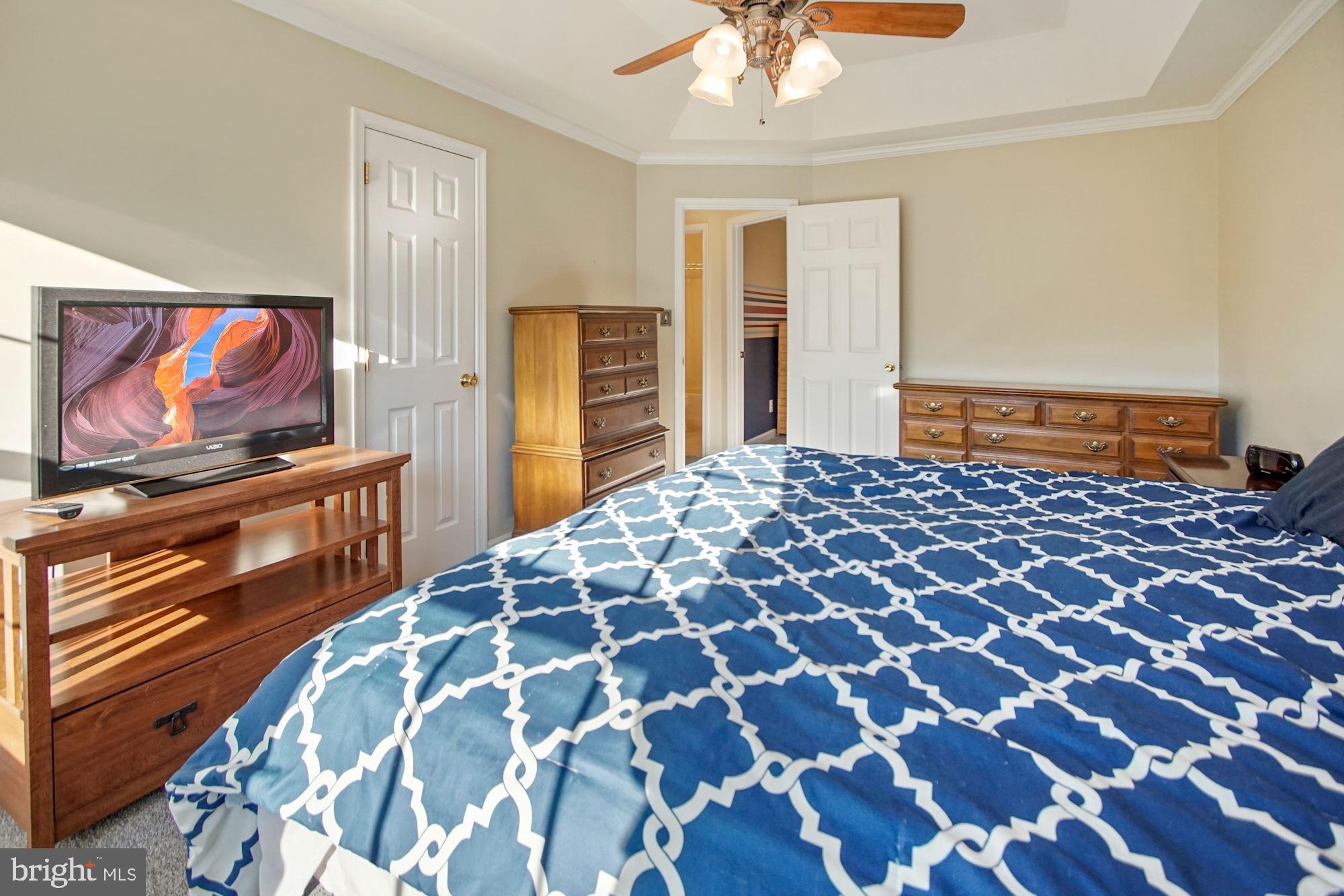 1731 Lottie Fowler Road Prince Frederick, MD 20678 - Photo 22 of 41 Primary bedroom with tray ceiling & walk-in closet