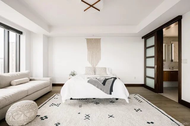 a living room with furniture and a floor to ceiling window