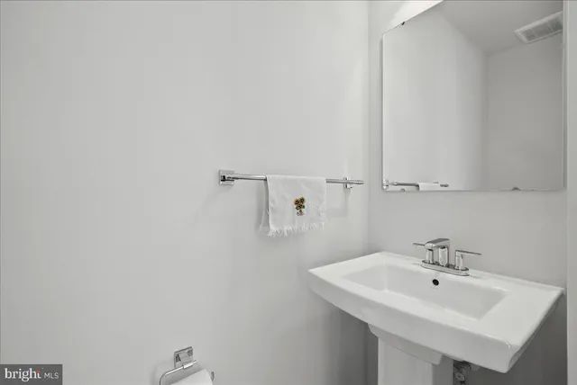 a bathroom with a bathtub shower sink vanity and toilet