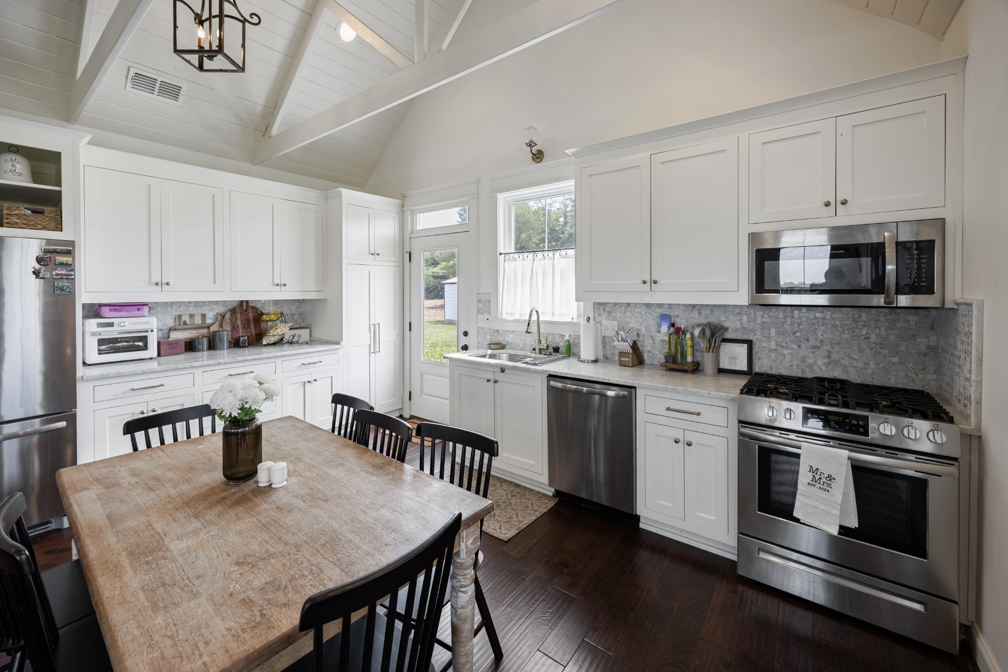 1687 Georgia Crossing Road Winchester, TN 37398 - Photo 5 of 38 a kitchen with stainless steel appliances granite countertop a stove a sink a microwave a refrigerator white cabinets and wooden floor