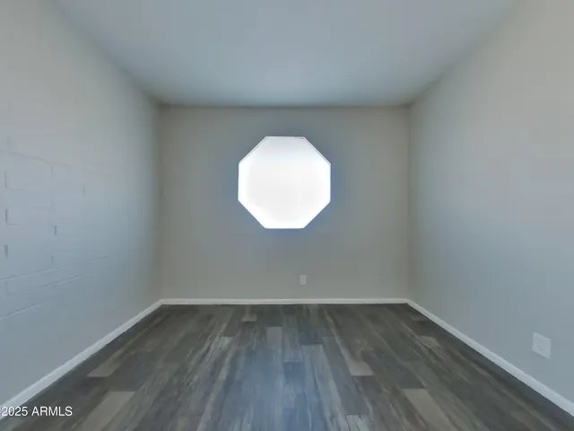 a view of a room with wooden floor and white walls