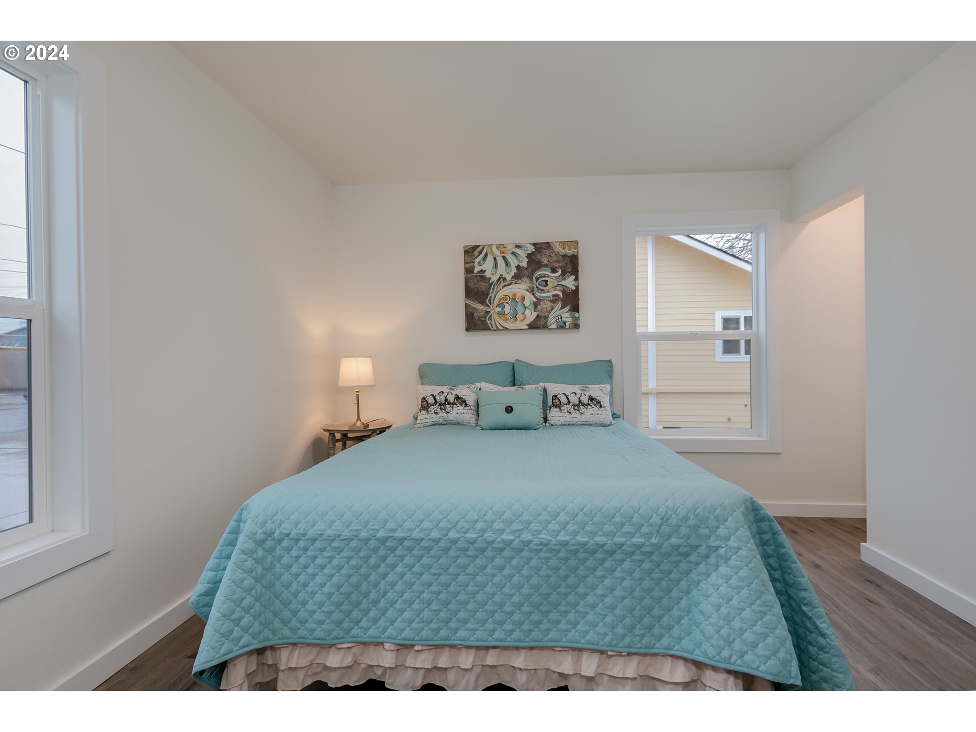 144 South 15th Street Springfield, OR 97477 - Photo 14 of 35 a bedroom with a bed and a painting on the wall