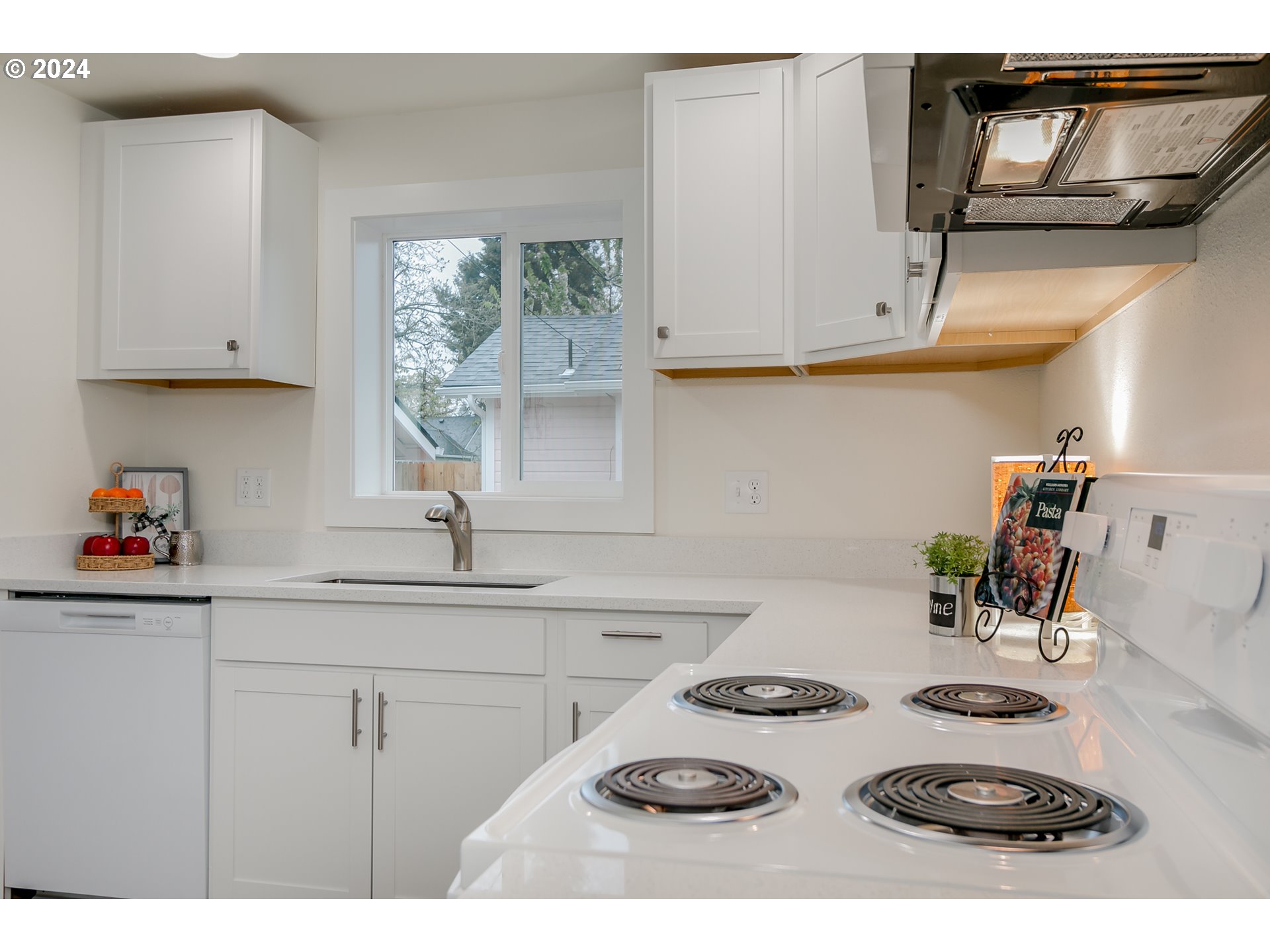 144 South 15th Street Springfield, OR 97477 - Photo 7 of 35 a kitchen with a sink a stove and cabinets