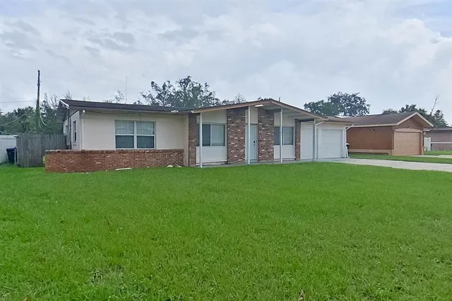 a view of a house with a yard and sitting area
